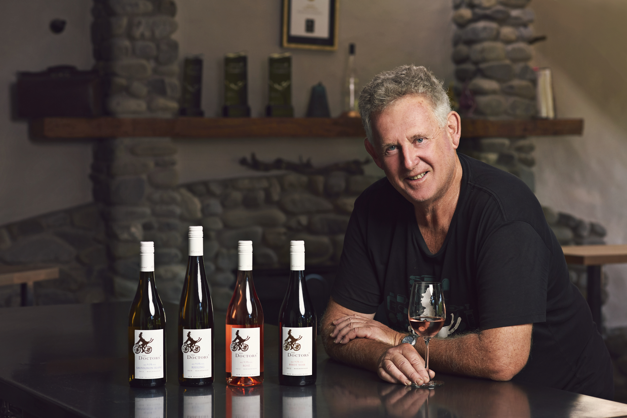 Dr John Forrest with four bottles of his eponymous wines