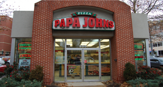 The exterior of a Papa John's pizza shop