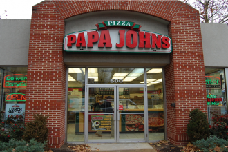 The exterior of a Papa John's pizza shop