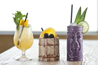 Three tiki cocktails on a table