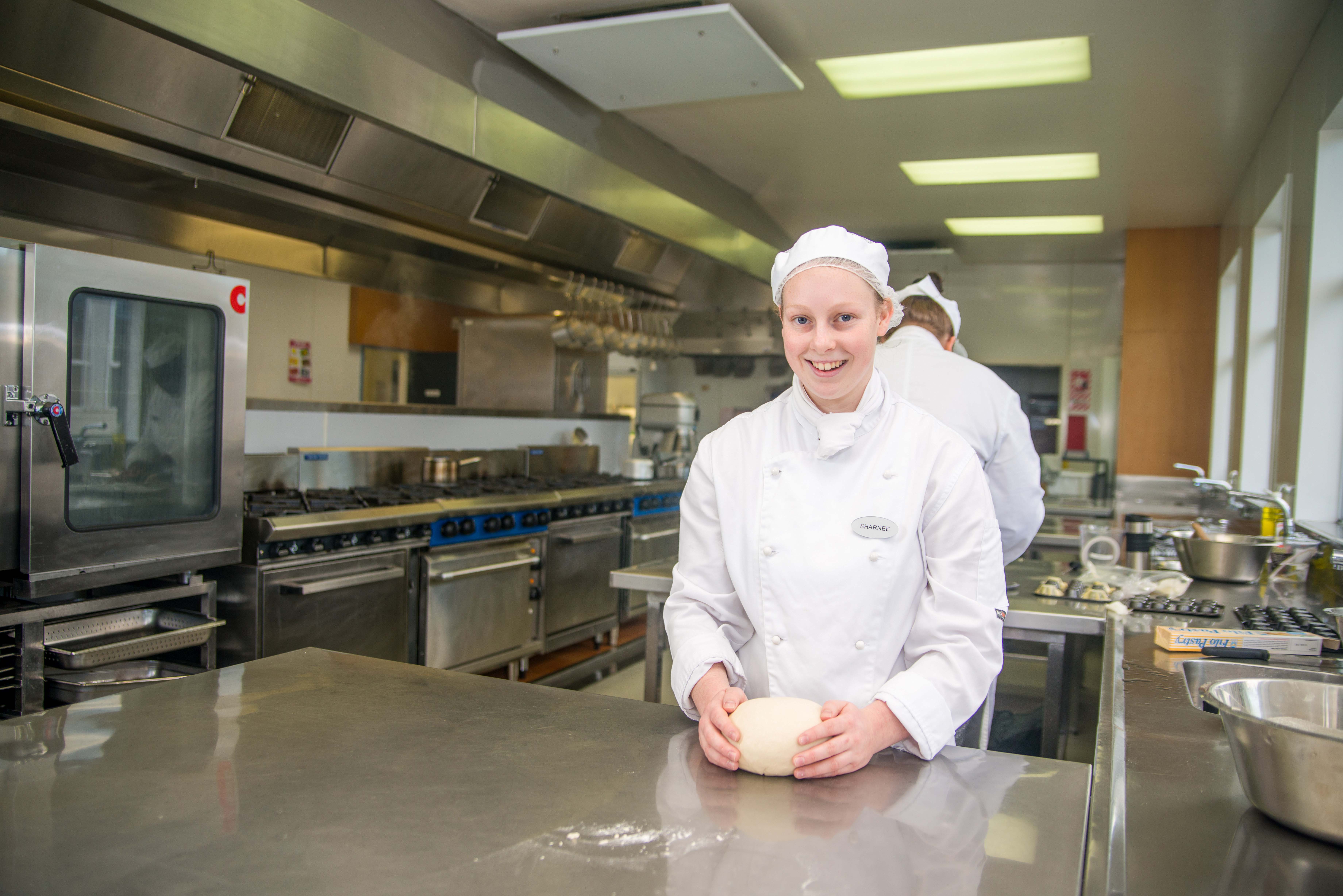 Sharnee Gardyne-Palmer stands in a commercial kitchen