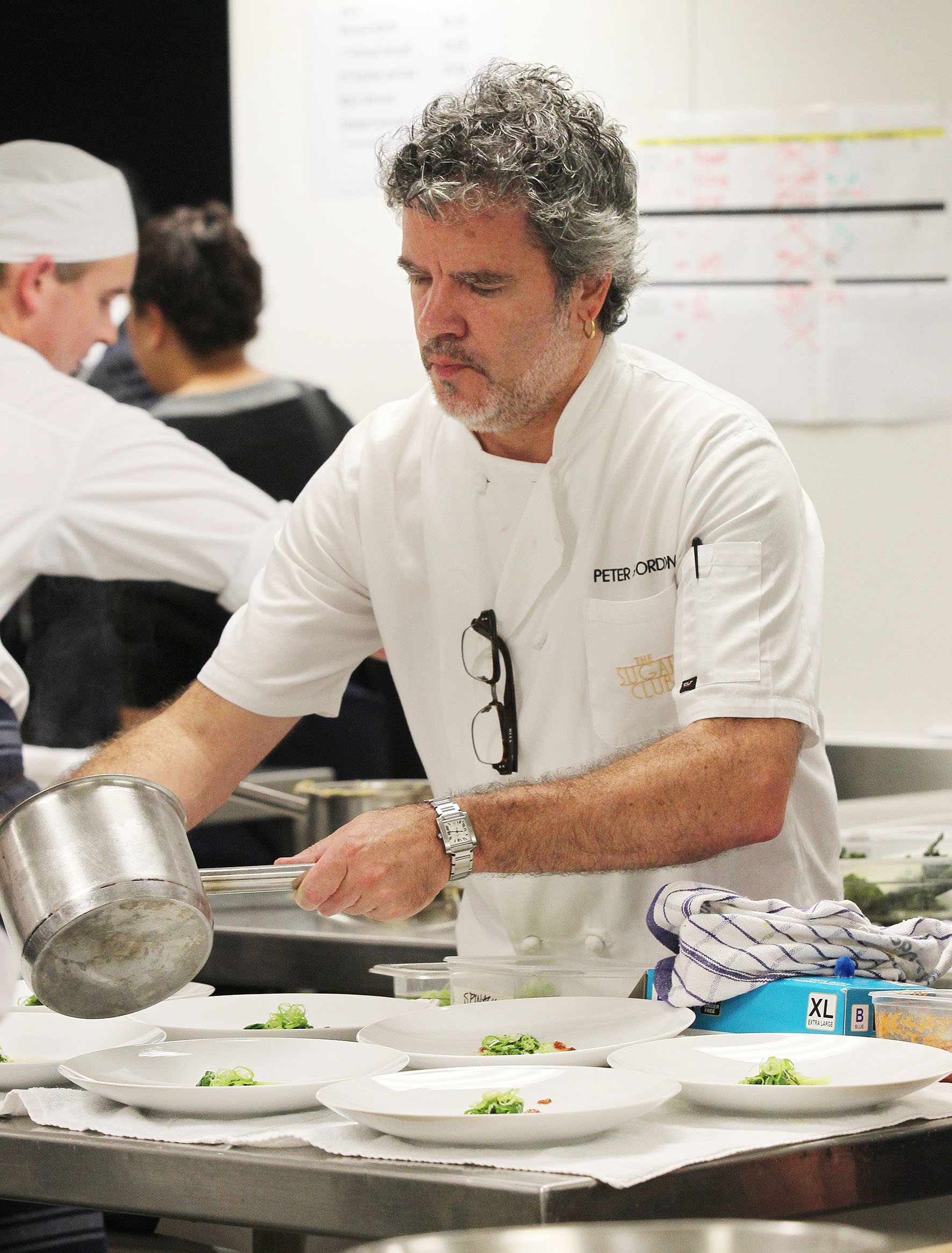 Peter Gordon prepares dishes for a Dining with a Difference event