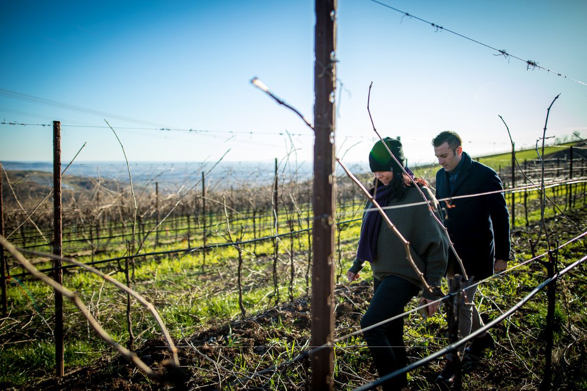 De Witt and man walking through vineyard