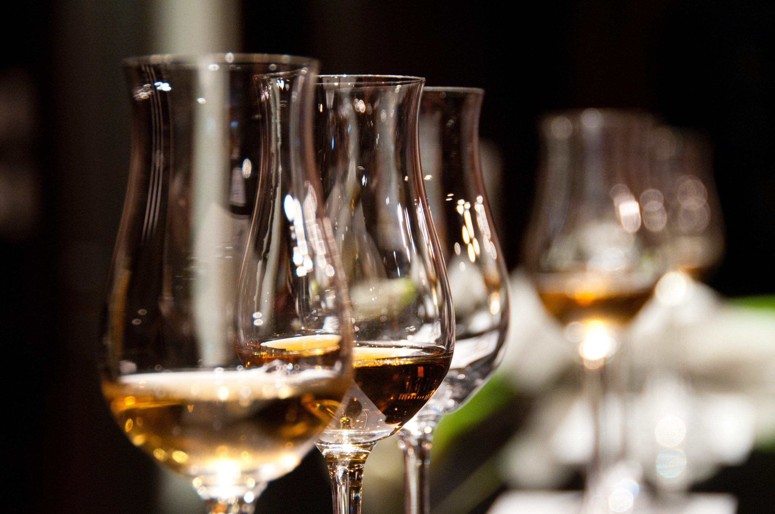 Landscape image of three Whisky Tasting glasses all with tasting samples